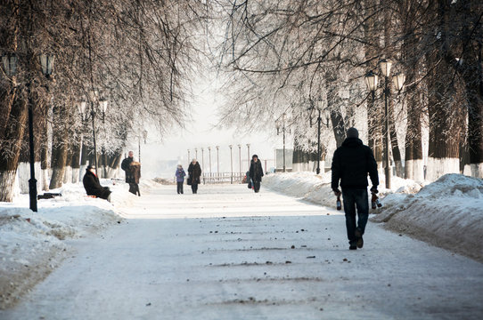 People walking by the park during the cold winter day in Yaroslavl, Russia