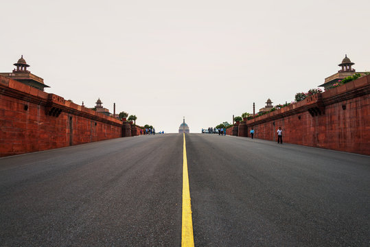 Empty road to the illuminated Rashtrapati Bhavan an Parliament building in Delhi, India