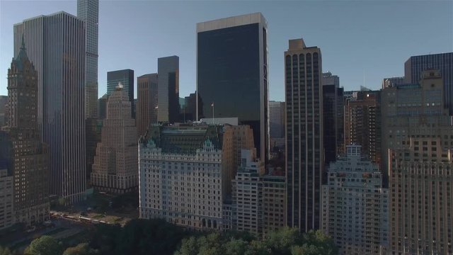 Real time aerial shot, camera is flying above Central Park, approaching the intersection of West 95th Street and 5th Avenue, New York City.