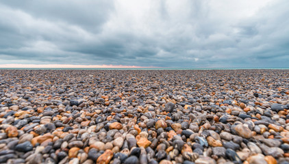 Fototapeta na wymiar Pebbles on a beautiful beach during a storm