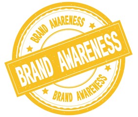 BRAND AWARENESS , written text on yellow round rubber stamp.