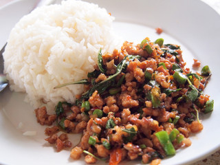 Close up Rice topped with stir fried pork and basil