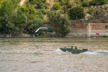 Naklejka premium Novi Sad, Serbia September 22, 2013: International Airshow in Novi Sad. Plane is flying over Danube river in front of Petrovaradin fortress