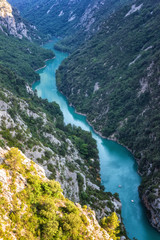 Verdon Gorge (Gorges du Verdon), amazing landscape of the famous canyon with winding turquoise-green colour river and high limestone rocks in French Alps, Provence, France, vertical image