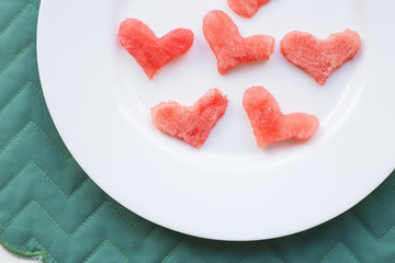 Fototapeta na wymiar watermelon heart shape on a white plate, close-up