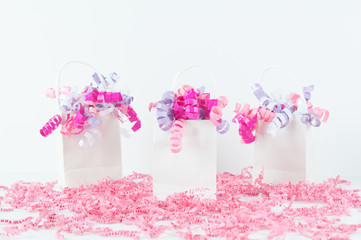 white bags wit hpink ribbon curls
