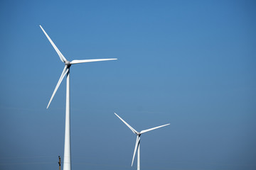 Fototapeta premium wind mill turbines with blue sky landscape