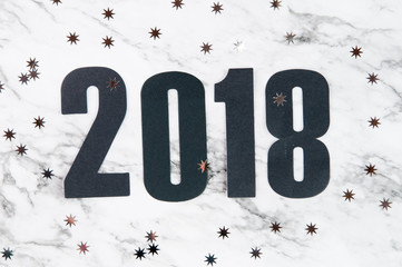 number 2018 on a marble background with silver stars
