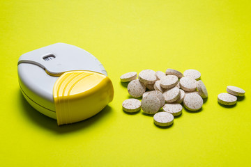 Inhaler and tablets on background