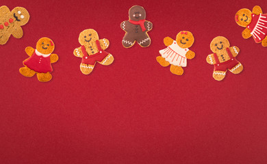 Christmas cookies of different shapes and sizes with a festive decor on a red background. Holiday Poster concept.  Empty place for a postural inscription