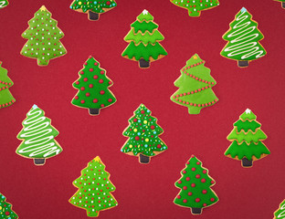 Christmas cookies of different shapes and sizes with a festive decor on a red background. Holiday Poster concept.