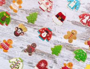 Christmas cookies of different shapes and sizes with a festive decor on a blue background. Holiday Poster concept.