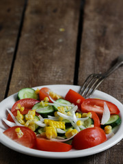 vegetable salad: tomato. cucumbers, onions and corn