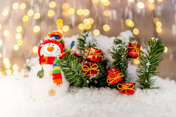 Fototapeta na wymiar Christmas decoration on a wooden background with snowman and snow