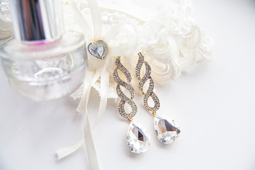 Beautiful set of wedding accessories, perfume and earrings
