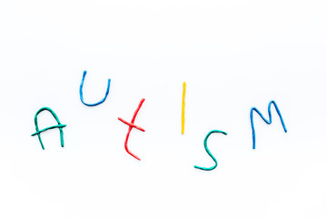Childhood diseases. Word autism on white background top view