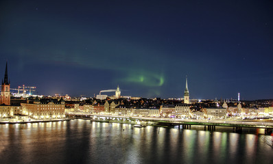 Fototapeta na wymiar Scenic night panorama of the Stockholm, Sweden with visible northern lights