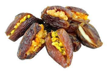 Stuffed dates filled with candied ginger and pistachio nuts isolated on a white background