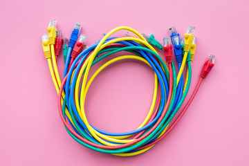 Network colored cables for computer on pink background top view