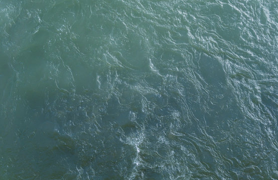 Glare And Reflective Surface Of The Rippling Water In The River Background