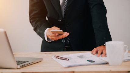Business man working at office with laptop and documents on his desk