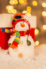 Christmas decoration on a wooden background with snowman and snow