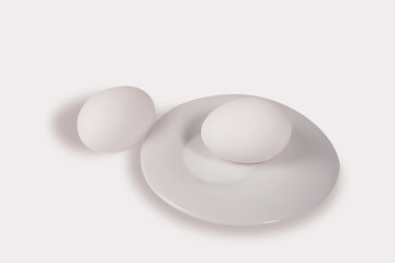 two eggs and a white plate on white