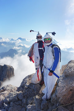 Portrait of two wingsuit BASE jumpers preparing to fly