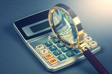 magnifying glass and calculator