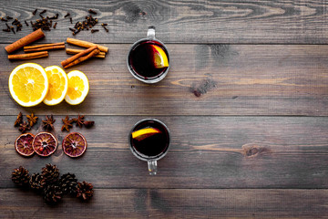 Ingredients for mulled wine. Spices cinnamon and badian, citrus fruits on dark wooden background...