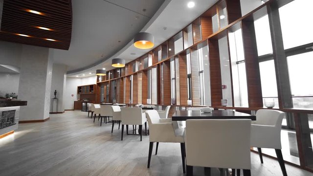 Video panorama of the cafe, tables and lamps, big windows, cozy atmosphere at the restaurant, interior's design