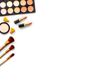 Professional bulk cosmetics. Eyeshadows, rouge, brushes on white background top view copyspace
