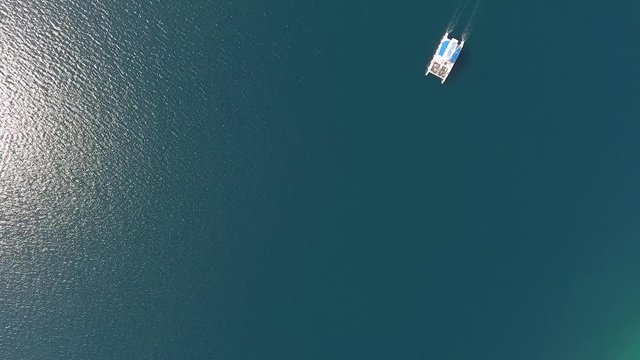 Lone sailboat on the sea surface. Aerial top view 4k

