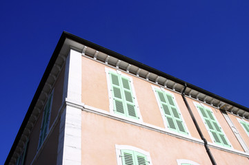 Fototapeta na wymiar Pink building and green shutters, Annecy, Savoy France
