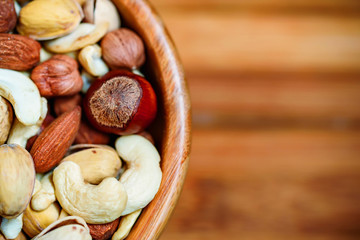 Assorted nuts in wooden bowl