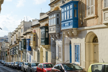 Fototapeta na wymiar The traditional Maltese colorful wooden balconies in Sliema on Malta
