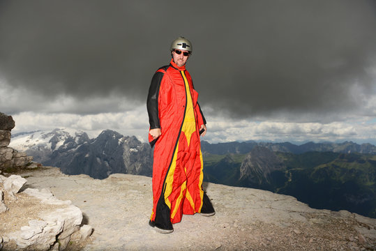 Portrait of base jumper on Dolomite mountains wearing wingsuit, Canazei, Trentino Alto Adige, Italy, Europe