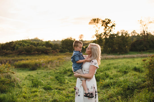 Mother holding son in rural area