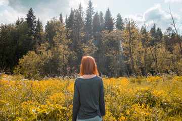 Woman standing in field, looking at view, rear view, Ural, Chelyabinsk, Russia, Europe