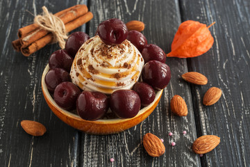 Meringue cake with cherry and almonds. A delicious dessert is sprinkled with chocolate.