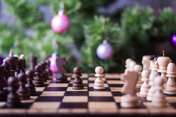 Christmas tree and chess board with figures.