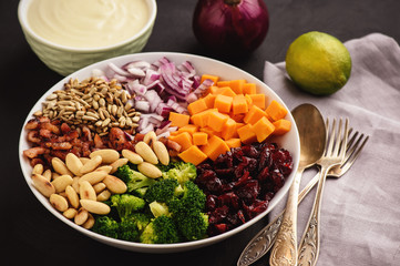 Broccoli salad with yogurt dressing, cheese, bacon, almond and cranberries.