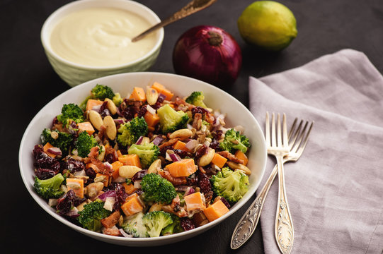 Broccoli salad with yogurt dressing, cheese, bacon, almond and cranberries.