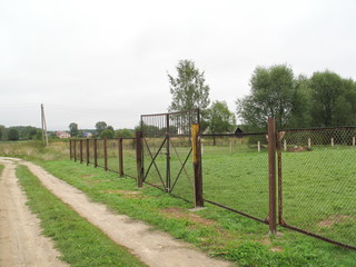 harvest in the garden, plowed field, yellow grass, fence