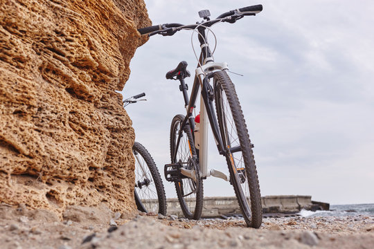 Bikes leaning against rock on beach, Odessa, Odeska Oblast, Ukraine, Europe