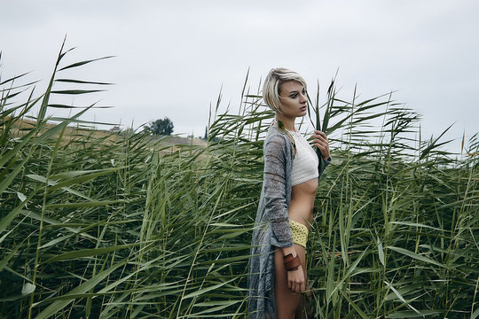 Side view of woman in tall grass looking away, Odessa, Odeska Oblast, Ukraine, Europe