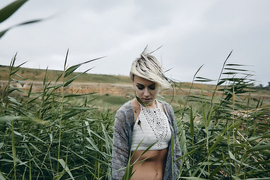 Woman in tall grass looking down, Odessa, Odeska Oblast, Ukraine, Europe