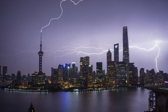 Elevated cityscape with lightning striking oriental pearl tower at night, Shanghai, China