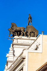 Sculpture of a chariot, over a bank building on the street Alcala. Copy space for text. Vertical