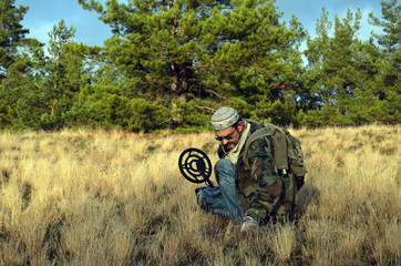 Man with metal detector,wears traditional Kazakh hat.Near Kiev
